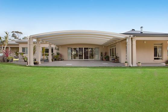 Patio Roofing Design Ideas  You can't imagine a more elegant looking patio roof for this home design.  It's perfect.